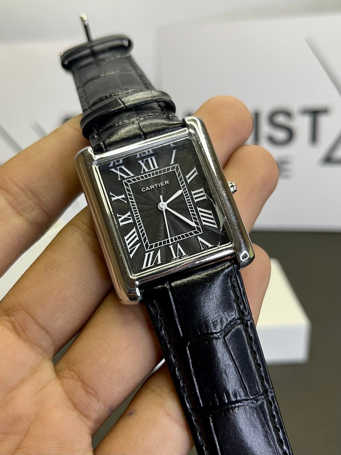 Cartier Tank watch with black dial