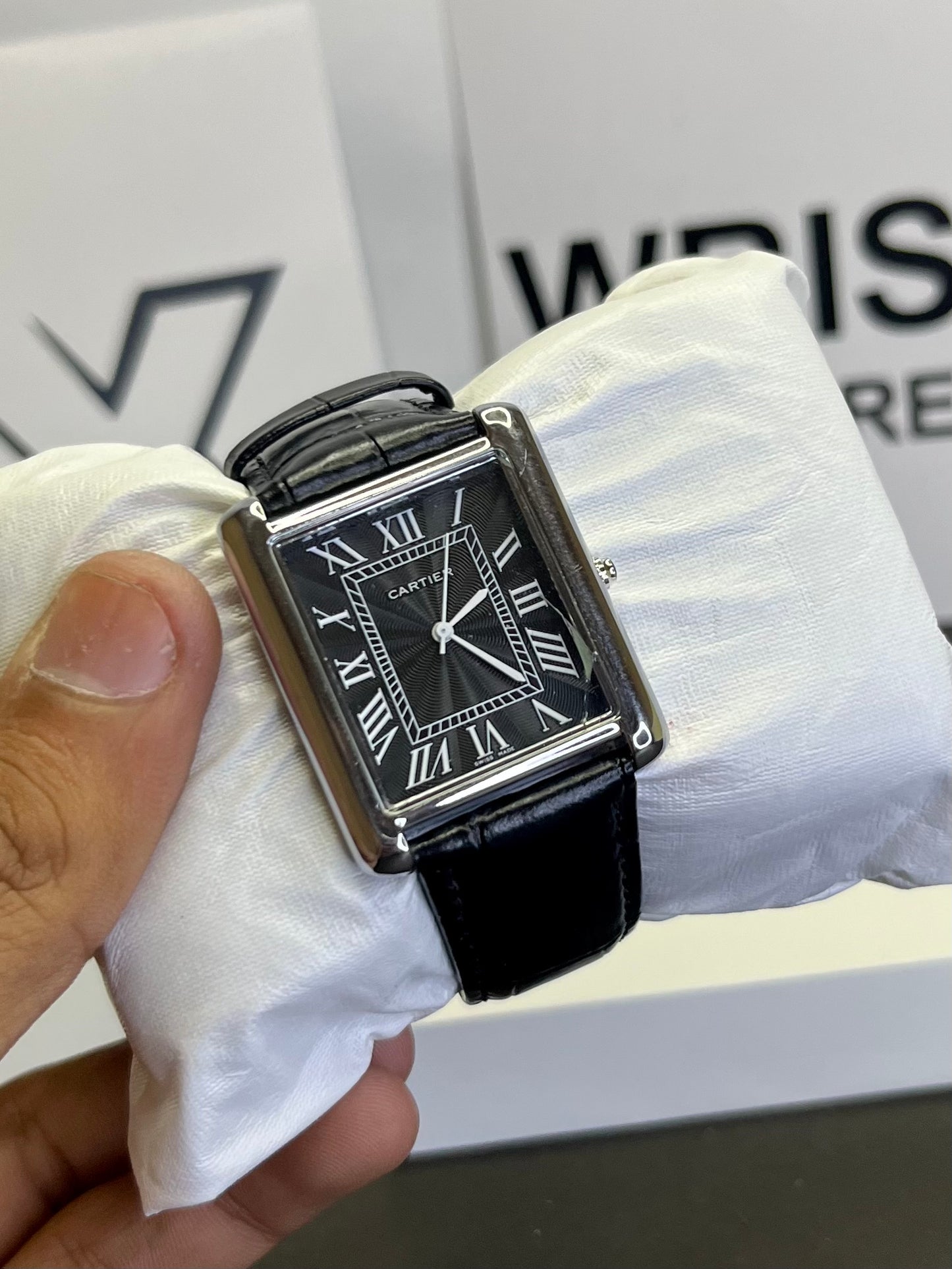 Cartier Tank watch with black dial